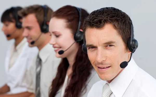 Attractive man working with his team in a call center — Stock Photo, Image