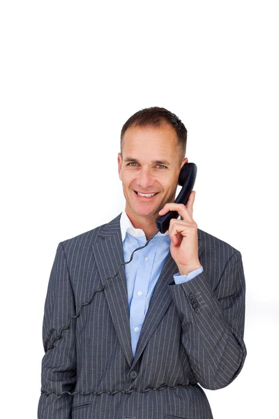 Homme d'affaires souriant empêtré dans les fils de téléphone — Photo