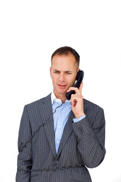 Sfrustrowany biznesmen zaplątane w telefon przewody — Zdjęcie stockowe