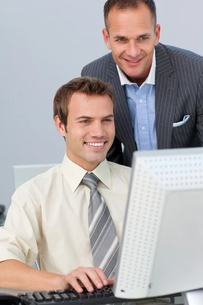 Mature manager checking his employee's work — Stock Photo, Image