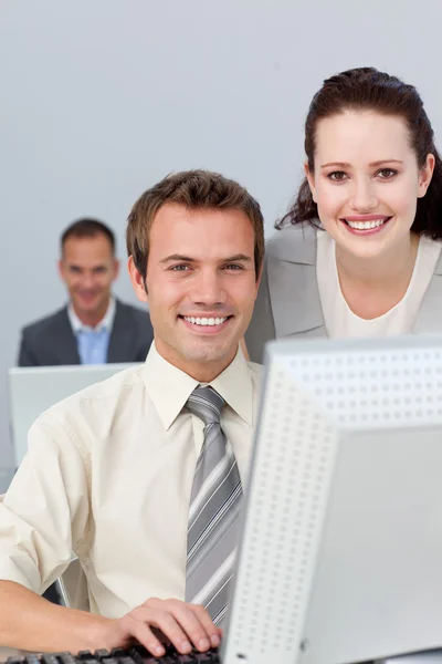 Young business partners working together at a computer — Stock Photo, Image