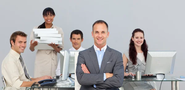 Self-assured manager with folded arms with his team — Stock Photo, Image