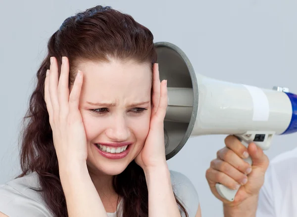 Portrait of a businesswoman getting nervous with a megaphone — Stock Photo, Image