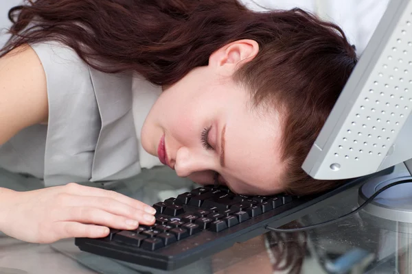 Businesswoman sleeping on the keyboard in the office — Stock Photo, Image