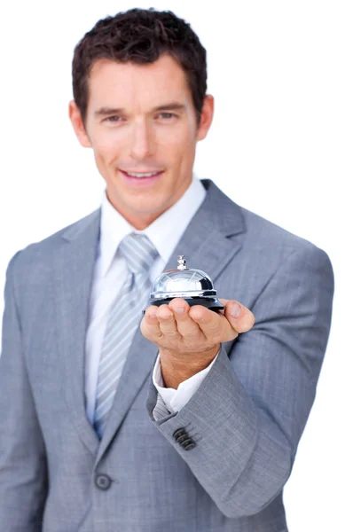 Улыбающийся бизнесмен с колокольчиком в руке — стоковое фото