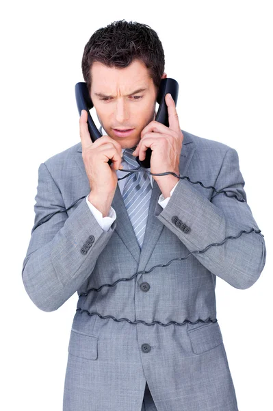 Un homme d'affaires stressé s'emmêle dans les fils de téléphone — Photo