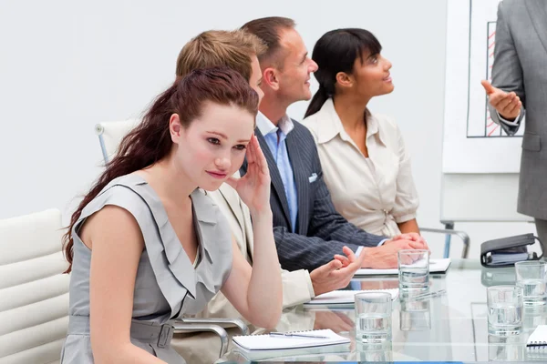 Businesswoman getting tired in a meeting — Stock Photo, Image