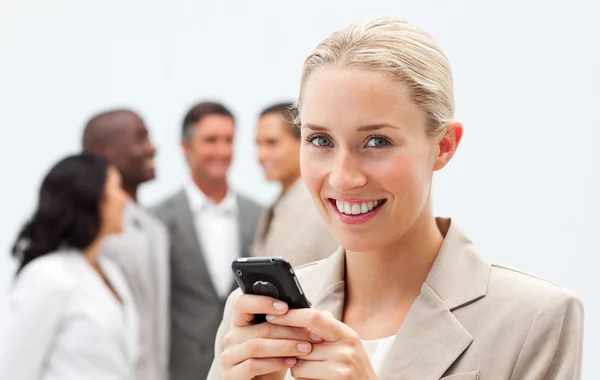 Lächelnde Geschäftsfrau schreibt eine Nachricht mit dem Handy — Stockfoto