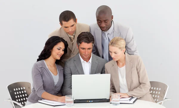 Multi-ethnic business team working with a laptop together — Stock Photo, Image