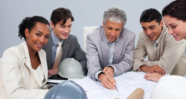 Architects in a meeting studying plans — Stock Photo, Image