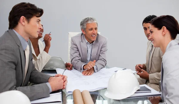 Architects in a meeting studying plans — Stock Photo, Image