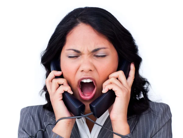 Frustrated businesswoman tangled up in phone wires — Stock Photo, Image