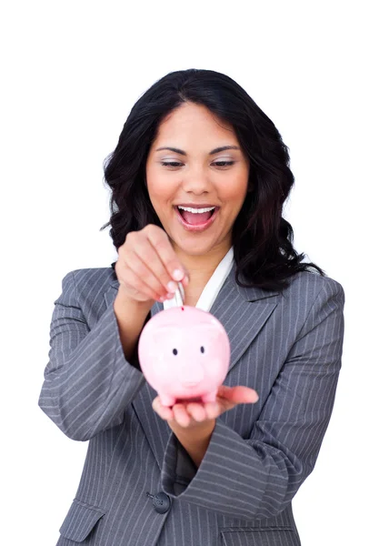 Feliz mujer de negocios étnica ahorrando dinero en una hucha — Foto de Stock