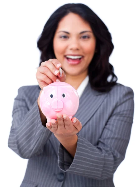 Self-assured young businesswoman saving money in a piggybank — Stock Photo, Image