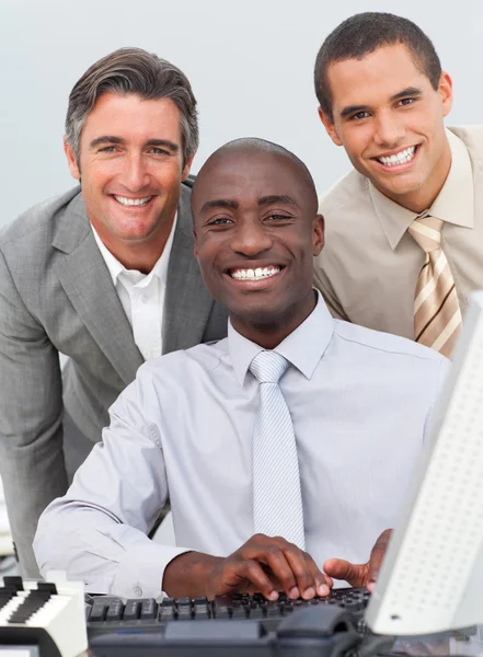 Multi-ethnic businessmen working at a computer — Stock Photo, Image