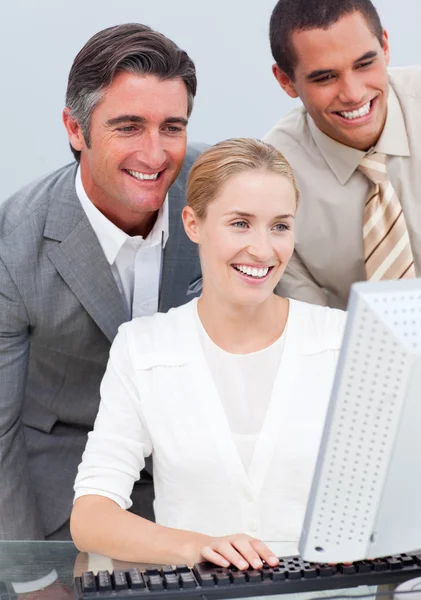 Self-assured business team working at a computer — Stock Photo, Image
