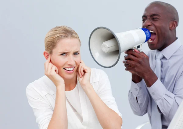 Angry businessman shouting through a megaphone — Stock Photo, Image
