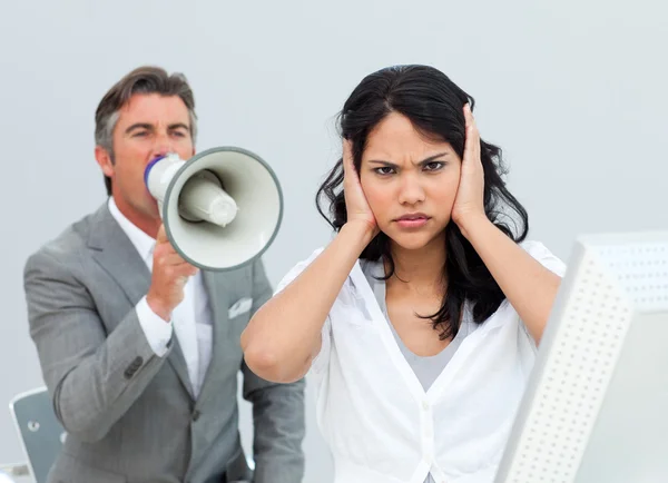 Competitive businessman shouting through a megaphone — Stock Photo, Image