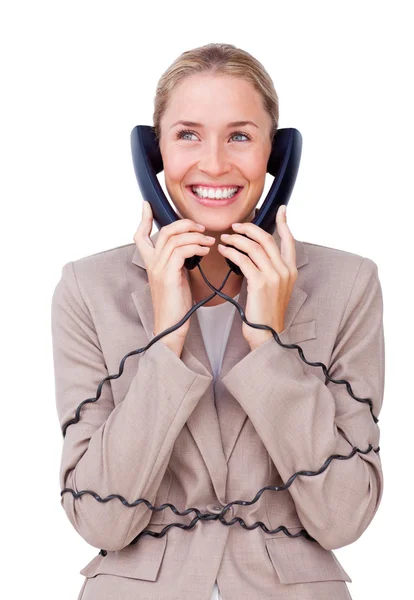 Charmante zakenvrouw verstrikt in telefoon draden — Stockfoto