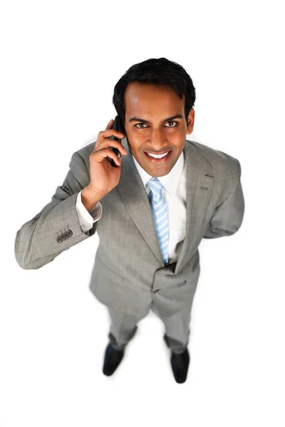 Positive ethnic businessman on phone — Stock Photo, Image