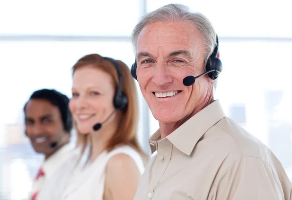 Senior businessman working in a call center — Stock Photo, Image