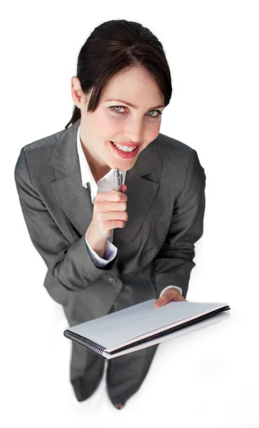 Smiling young businesswoman taking notes — Stock Photo, Image