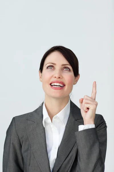 Positive businesswoman pointing at a copyspace — Stock Photo, Image