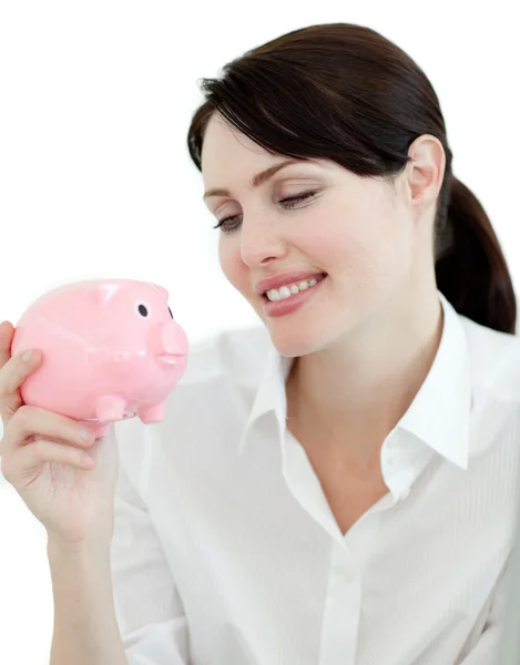 Attraktiva affärskvinna tittar på en piggybank — Stockfoto
