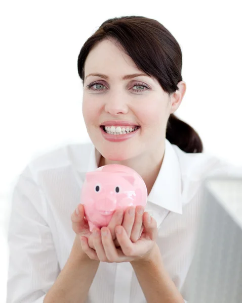 Businesswoman holding a piggybank against a white background — Stock Photo, Image