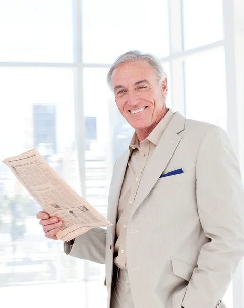 Portrait of a smiling manager reading newspaper — Stock Photo, Image