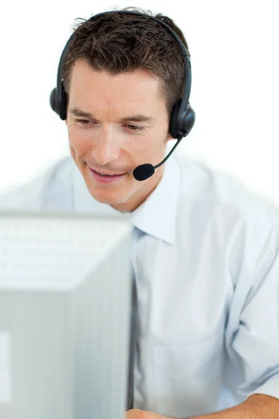 Businessman with headset on working at a computer — Stock Photo, Image