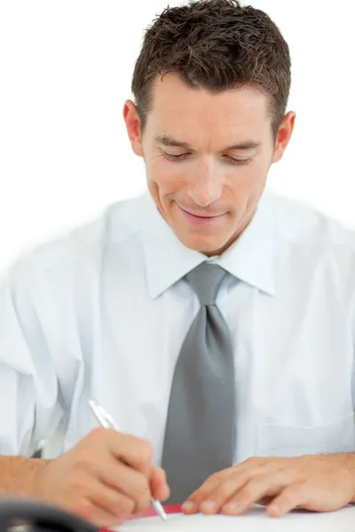Portrait of a smiling businessman writing — Stock Photo, Image