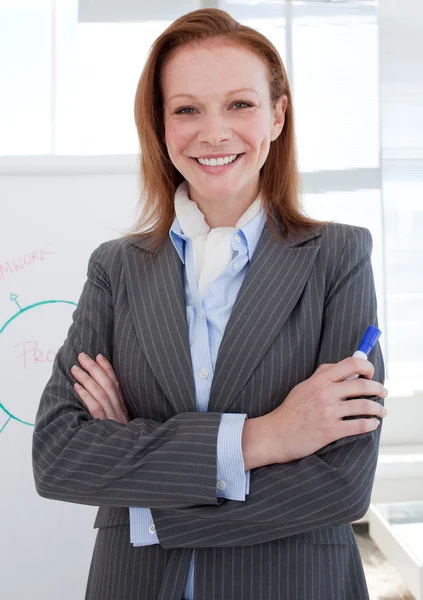 Attractive businesswoman in front of a white board — Stock Photo, Image