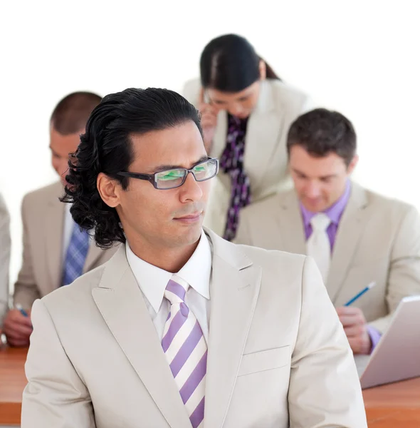 Serious businessman with his team in the background — Stock Photo, Image