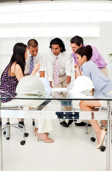 A group of architects and their manager discussing blueprints — Stock Photo, Image