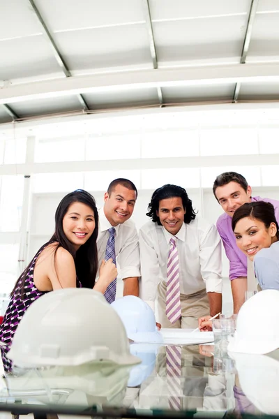 Architects smiling at the camera in a meeting — Stock Photo, Image