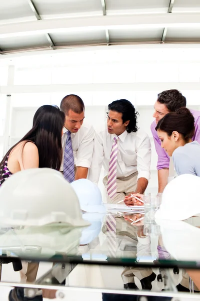 A group of engineers and their manager discussing blueprints — Stock Photo, Image
