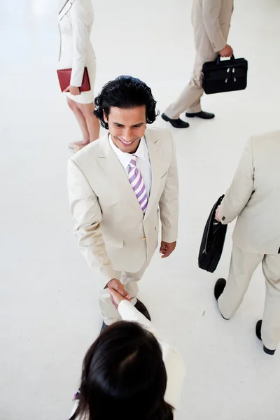 Business shaking hands in a business building — Stock Photo, Image