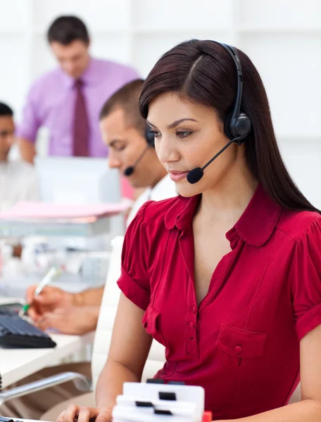 Concentrated Businesswoman using headset — Stock Photo, Image