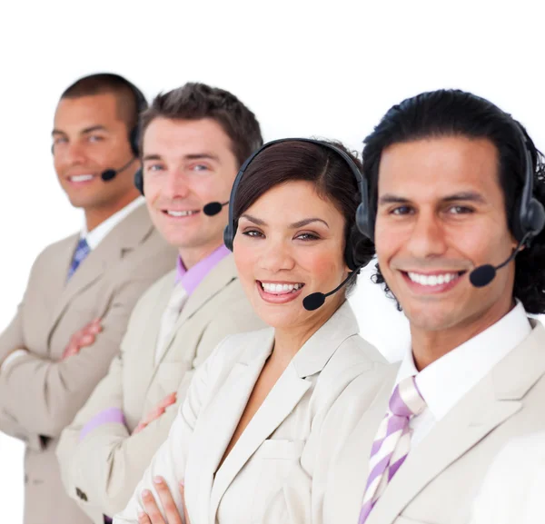 Sorrindo equipe de negócios alinhados com fone de ouvido em — Fotografia de Stock