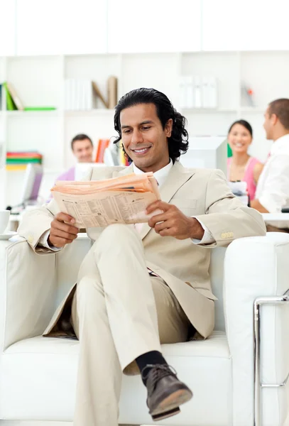 Smiling manager reading a newspaper — Stock Photo, Image