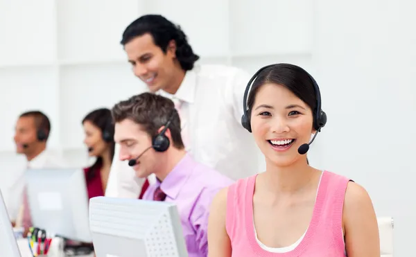 Portrait of an Asian customer agent and her team — Stock Photo, Image