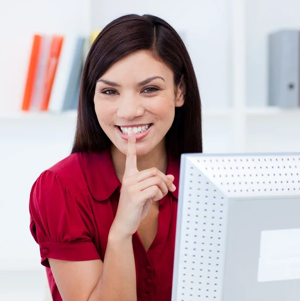 Close-up of a smiling businesswoman askig for silence — Stock Photo, Image