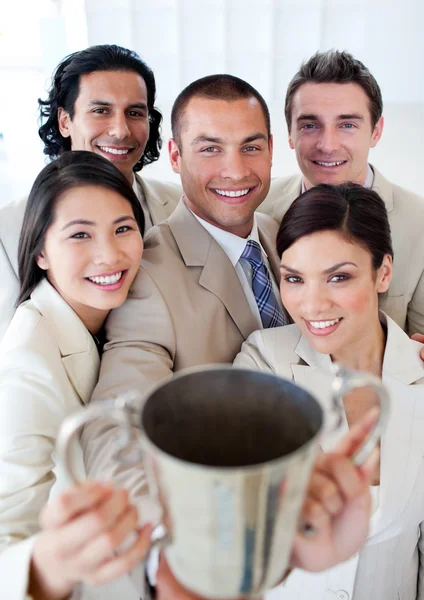 Victorious business team showing their throphy — Stock Photo, Image