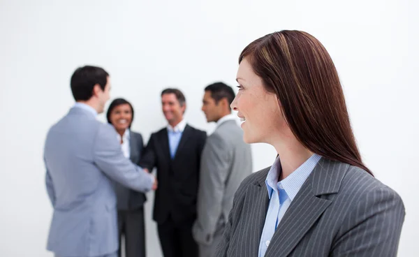 Attractive female executive looking at her team — Stock Photo, Image