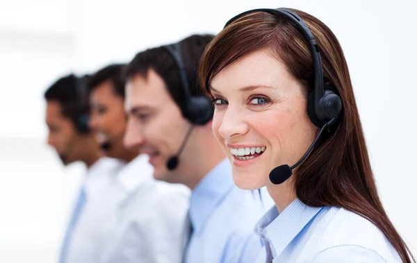 Businesswoman with headset on smiling at the camera — Stock Photo, Image