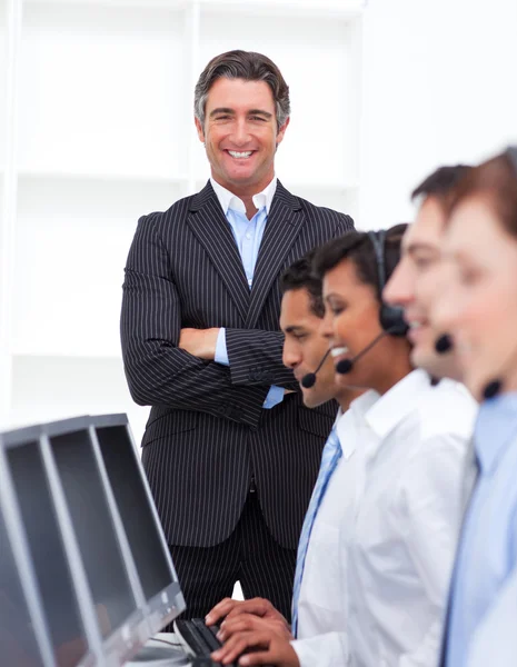 Self-assured businessman presenting a call center — Stock Photo, Image