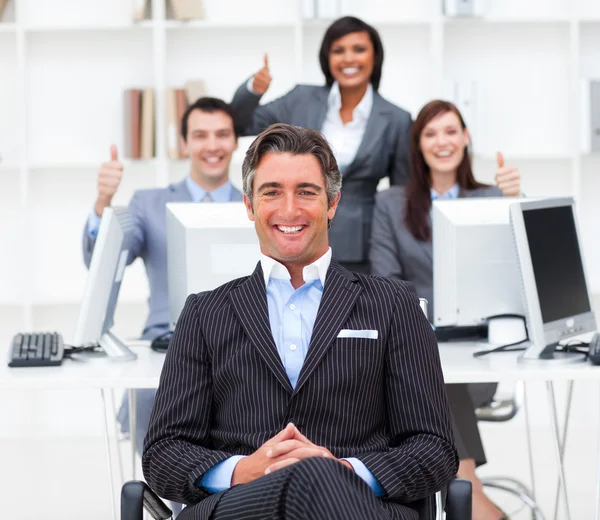 Cheerful businesspeople with thumbs up — Stock Photo, Image