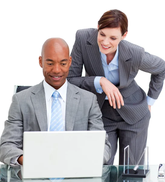 Brunette manager assisting her colleague at a computer — Stock Photo, Image