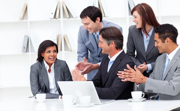 Laughing businesswoman applauded by her team — Stock Photo, Image